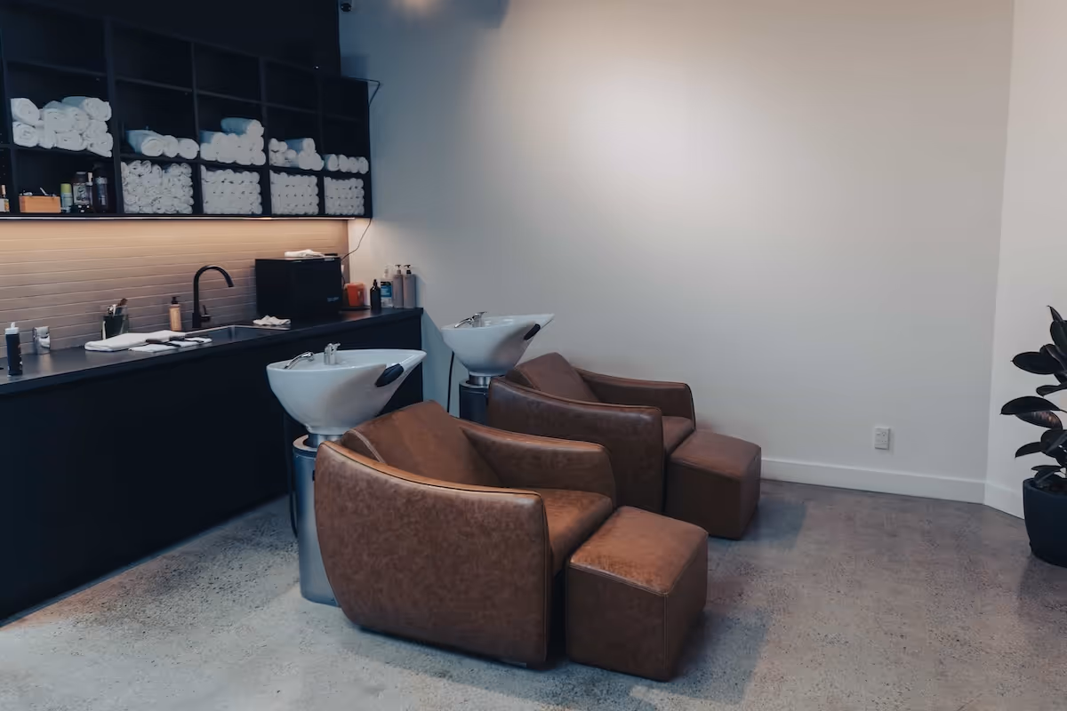 The comfortable client lounge area with leather armchairs and a clean, minimalist design.