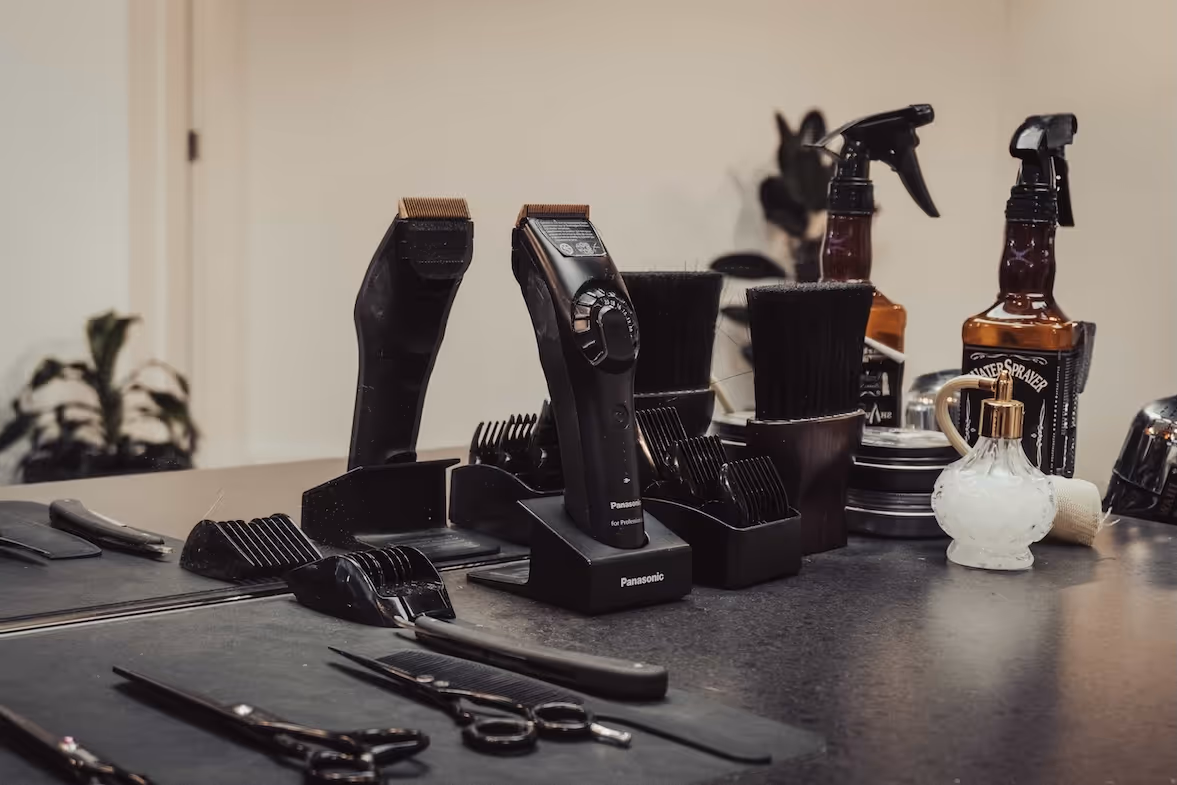 A professional barber's station with a variety of classic and modern grooming tools.